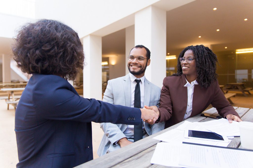 Satisfied customers thanking professional for help